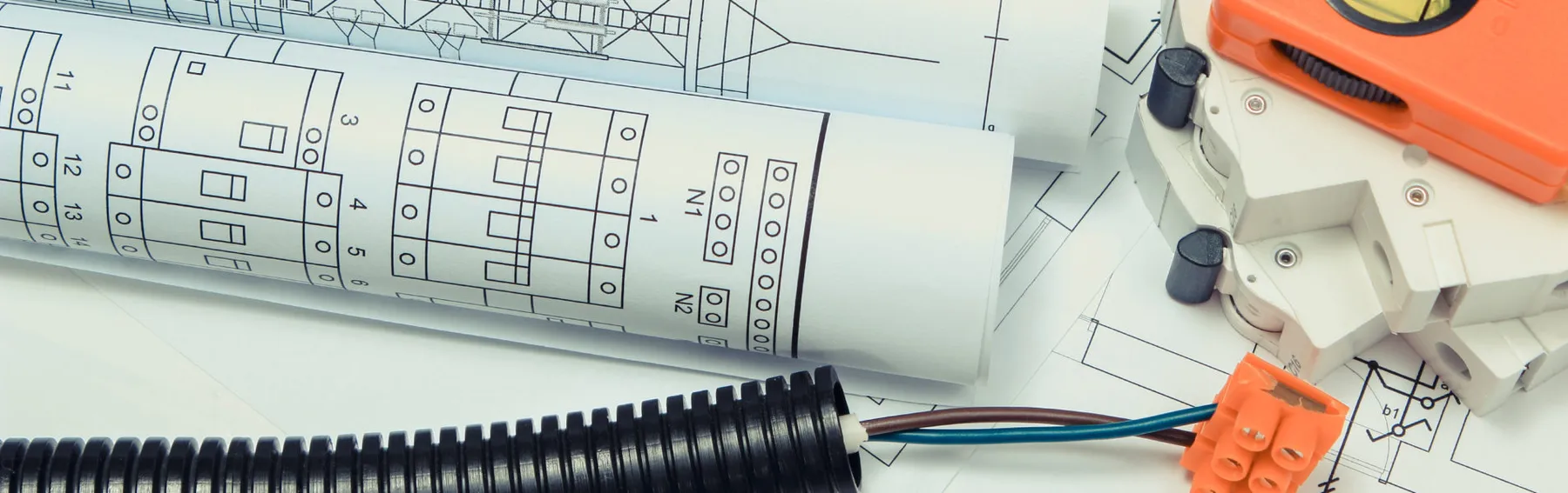Home building plans with electrical components on the paper