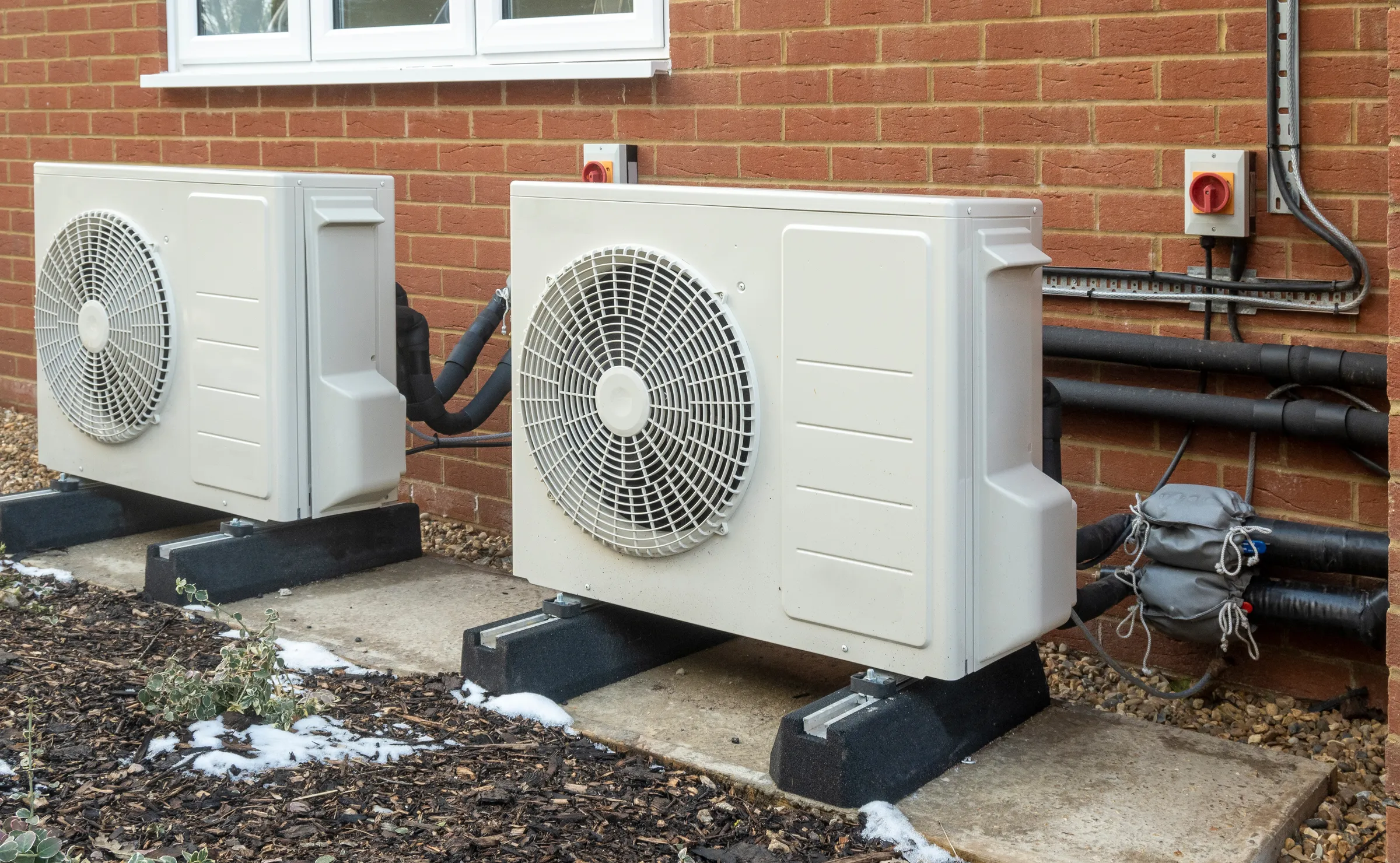 2 heat pumps outside of a residence